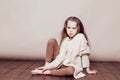 Little girl sitting on the floor and sad Royalty Free Stock Photo