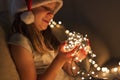 Little girl setting up Christmas lights