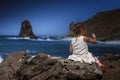 Beautiful little girl sitting on a rock and looking into the dis Royalty Free Stock Photo