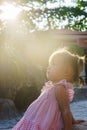 Beautiful little girl is sitting on a rock the sunset. towers Ponagar. Vietnam. Royalty Free Stock Photo