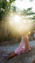 Beautiful little girl is sitting on a rock the sunset. towers Ponagar. Vietnam. Royalty Free Stock Photo