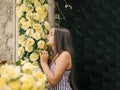 Beautiful little girl smell flowers in garden Royalty Free Stock Photo