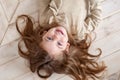 Beautiful little girl smiling lying on the floor. Royalty Free Stock Photo