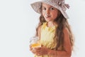 Beautiful little girl with spoon in mouth eating tasty cream. Eating yummy ice cream is fun