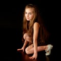 Beautiful little girl, studio portrait on a black background. Royalty Free Stock Photo