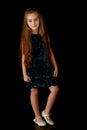 Beautiful little girl, studio portrait on a black background. Royalty Free Stock Photo