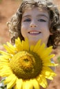 Beautiful little girl in a summer sunflower field Royalty Free Stock Photo