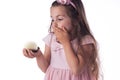 Beautiful little girl surprised from a tasty big chocolate coconut candy as a ball. Kid ready to eat cake Royalty Free Stock Photo