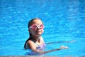 Beautiful little girl swims in the sea