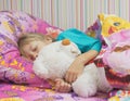 Beautiful little girl with a toy polar bear. Royalty Free Stock Photo