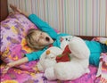 Beautiful little girl with a toy polar bear. Royalty Free Stock Photo