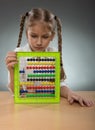 Beautiful little girl use abacus board