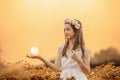 Beautiful girl in vintage dress and hat standing near colorful flowers Royalty Free Stock Photo