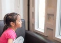 Beautiful little girl watching out the window Royalty Free Stock Photo