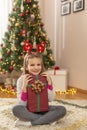 Little girl holding a Christmas gift Royalty Free Stock Photo