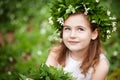 Beautiful  little girl in a white dress  in the spring wood. Portrait of the pretty little girl with a wreath from spring flowers Royalty Free Stock Photo