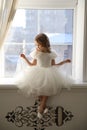 Kid girl is waiting for Santa Claus at window Royalty Free Stock Photo