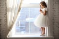 Kid girl is waiting for Santa Claus at window Royalty Free Stock Photo