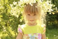 Beautiful little girl in a wreath of flowers on the nature Royalty Free Stock Photo