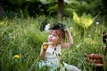 Beautiful little girl in a wreath on the head in green and white. Dress, Princess. With pleasure, but the nature Royalty Free Stock Photo