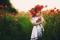 Beautiful little girl with a wreath of poppies on head. cute child in wild poppies field Royalty Free Stock Photo
