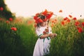 Beautiful little girl with a wreath of poppies on head. cute child in wild poppies field Royalty Free Stock Photo