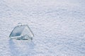 beautiful little glass, crystal house on background of white snow. Concept of real estate investment. Take out mortgage. Royalty Free Stock Photo