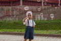 Beautiful little haired hair girl, has happy fun smiling face, pretty eyes, short hair, playing soap bubbles in white t