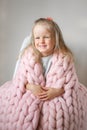 Beautiful Little Happy Blond Ginger Girl Sitting on Bed with a Pink Merino Woolen Blanket Royalty Free Stock Photo