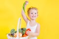 Beautiful little happy girl with basket of vegetables and fruits Royalty Free Stock Photo