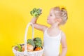 Beautiful little happy girl with basket of vegetables and fruits Royalty Free Stock Photo