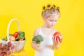 Beautiful little happy girl with basket of vegetables and fruits Royalty Free Stock Photo