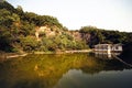 Beautiful little house by the lake on a background of mountains covered with trees Royalty Free Stock Photo