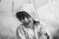Beautiful little kid boy on way to school walking during sleet, heavy rain and snow with an umbrella on cold day. Happy Royalty Free Stock Photo