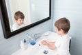 Beautiful little kid washes his hands in bathroom Royalty Free Stock Photo