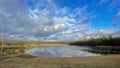 A beautiful little lake next to Frankfurt at a cold but sunny day in winter with beautiful cloudscape. Royalty Free Stock Photo