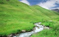 Beautiful little mountain stream in green mountains