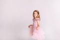 Beautiful little princess dancing in luxury pink dress