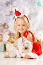 Beautiful little Santa girl near the Christmas tree. Happy girl Royalty Free Stock Photo