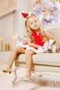 Beautiful little Santa girl near the Christmas tree. Happy girl Royalty Free Stock Photo