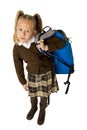 Beautiful little schoolgirl tired and exhausted carrying on her back heavy school backpack looking sad Royalty Free Stock Photo