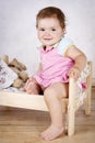 Beautiful little toddler having fun in the small bed Royalty Free Stock Photo