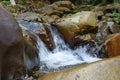 Beautiful little waterfall in mountains. Water flows between stones Royalty Free Stock Photo