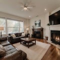 Beautiful living room with hardwood floors, fireplace and couch in new luxury home