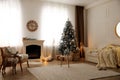 Beautiful living room interior with decorated Christmas tree and modern fireplace Royalty Free Stock Photo