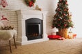 Beautiful living room interior with decorated Christmas tree and modern fireplace Royalty Free Stock Photo