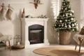 Beautiful living room interior with decorated Christmas tree and modern fireplace Royalty Free Stock Photo