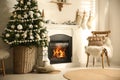 Beautiful living room interior with decorated Christmas tree and modern fireplace Royalty Free Stock Photo