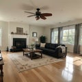 Beautiful living room interior with hardwood floors and fireplace in new luxury home Has view of kitchen hallway and loft area Royalty Free Stock Photo