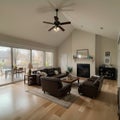 Beautiful living room interior with hardwood floors and fireplace in new luxury home Has view of kitchen hallway and loft area Royalty Free Stock Photo